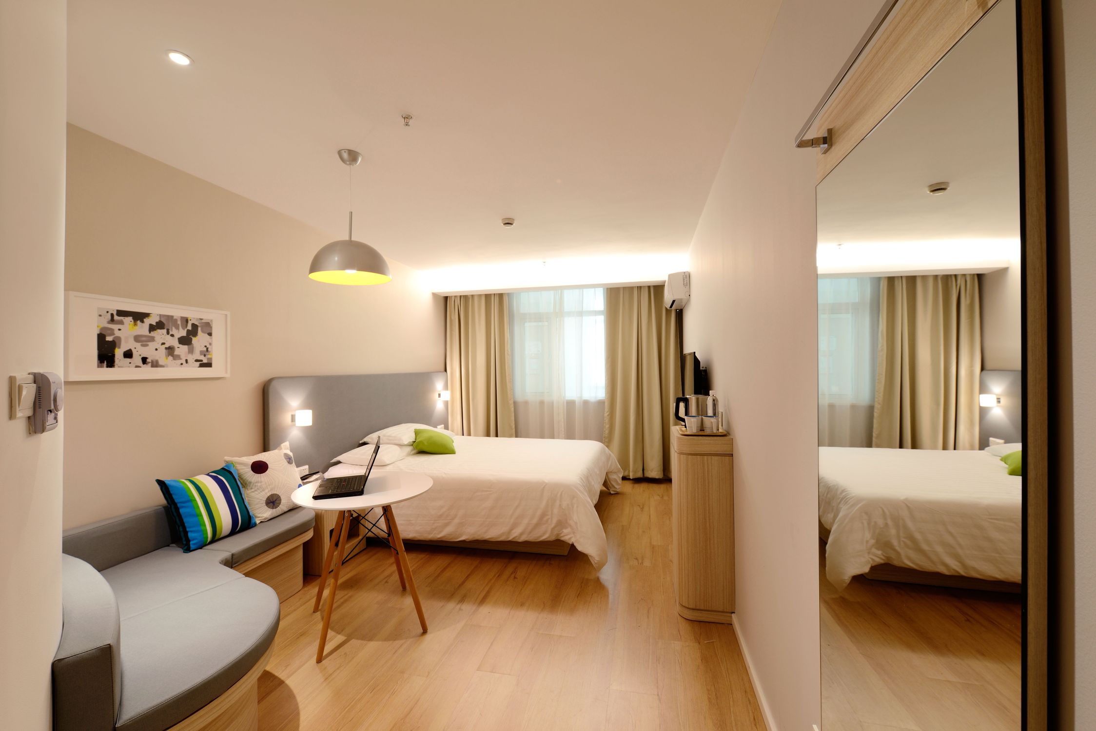 A cozy and modern hostel common area in Hong Kong with travelers relaxing